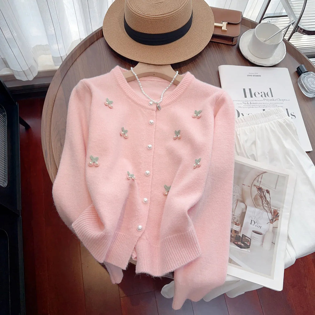 Women's cashmere cardigan coat in blue with beaded detail, shown with round neck and slim fit.
