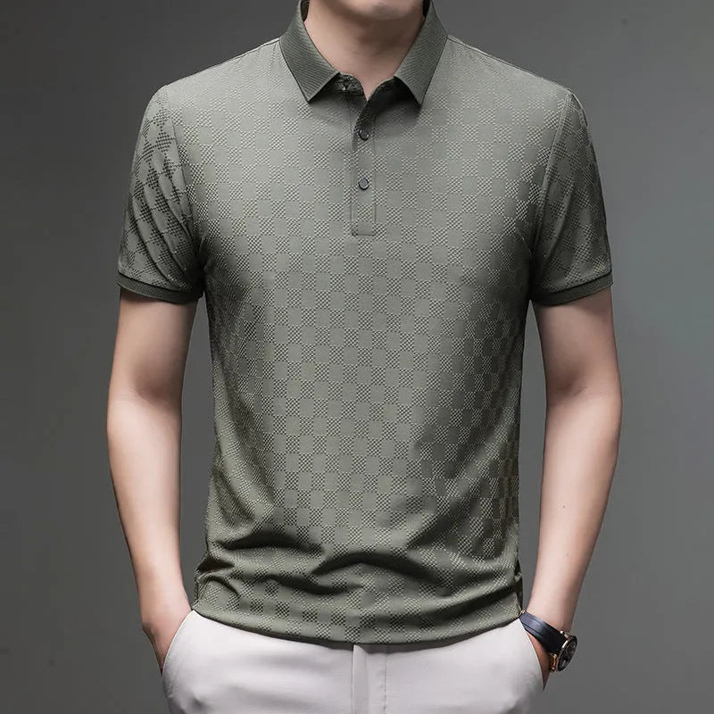 Man wearing a black rhombus patterned short sleeve t-shirt with a side slit detail.