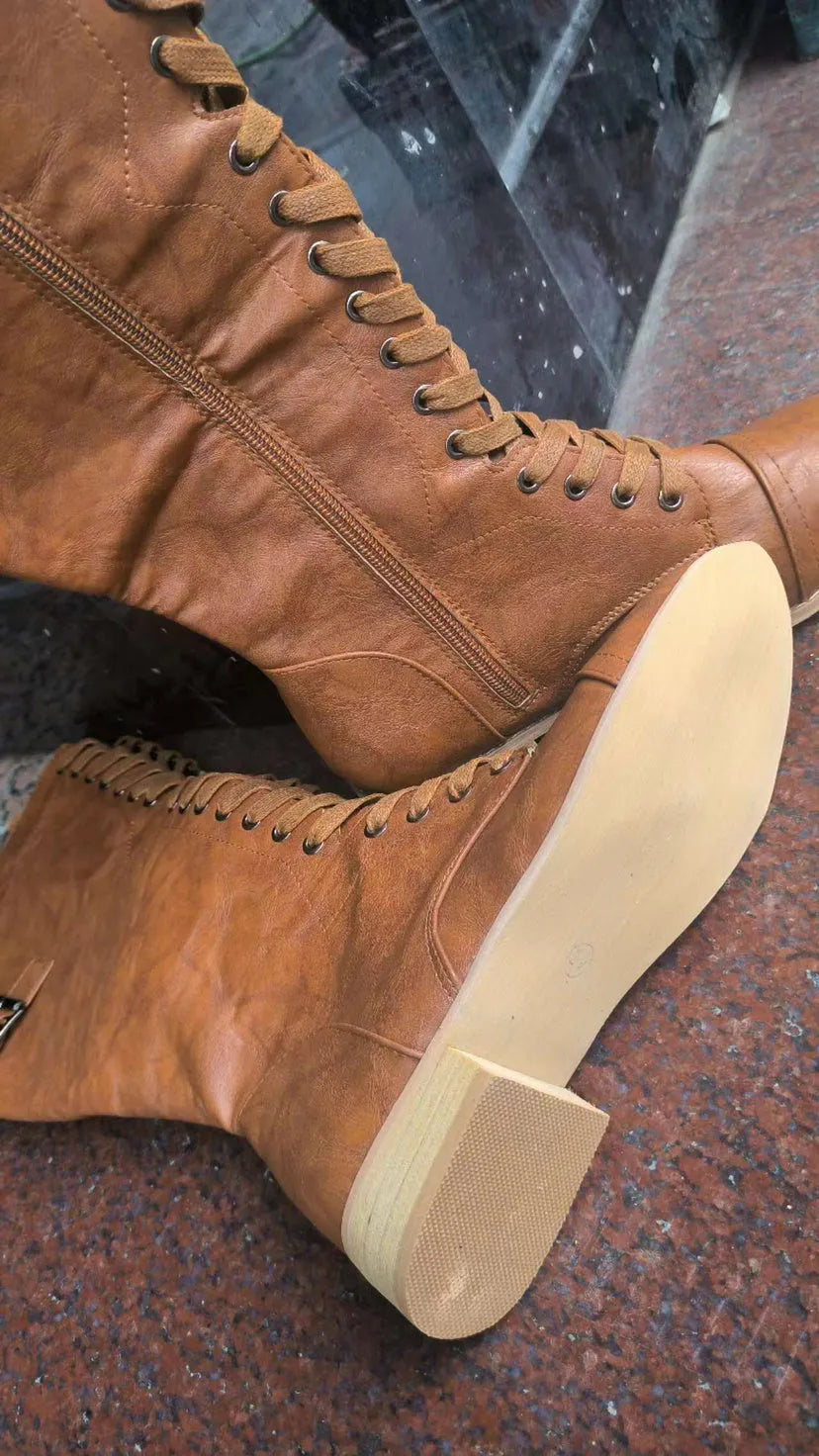 Women's black knight ankle boots with a cross strap detail on the ankle.