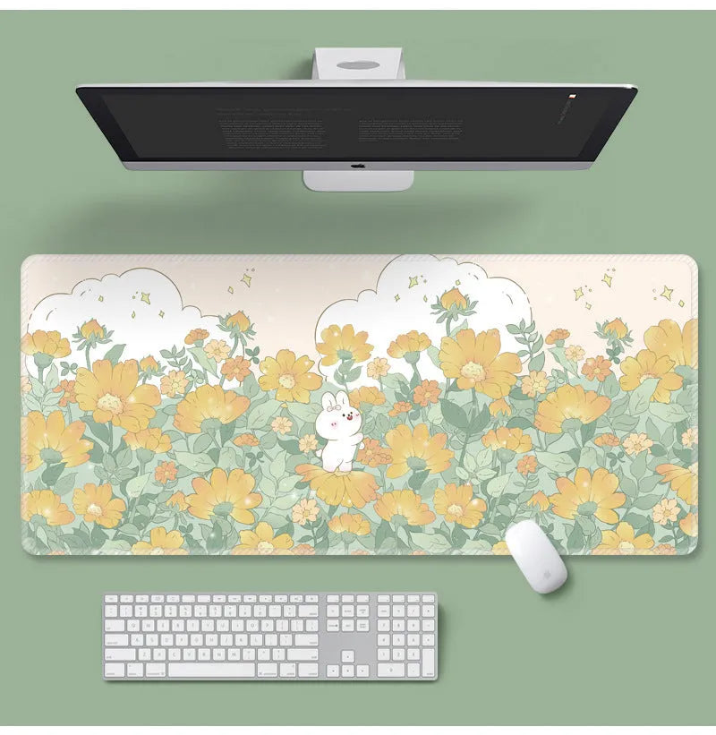 Large floral pattern mouse pad on a desk, showing non-slip rubber base and thin cloth surface.