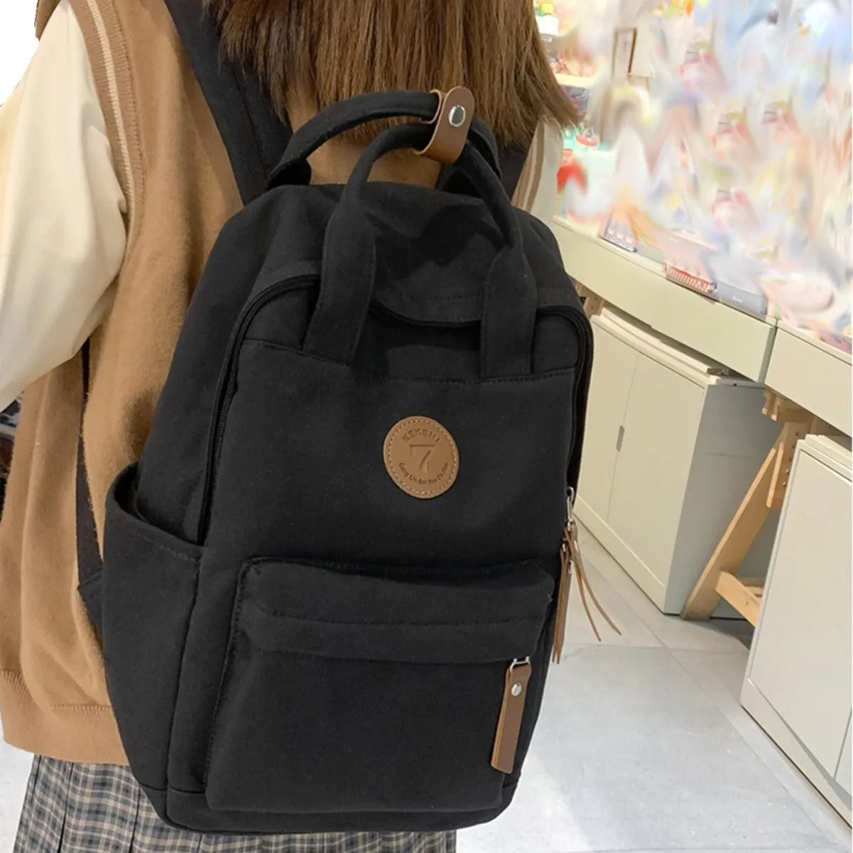 Black oxford cloth fashion backpack with curved shoulder straps and urban simplicity design