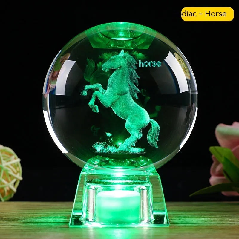 White crystal ball luminous ornament with Chinese zodiac animal design on an electronic charging base.