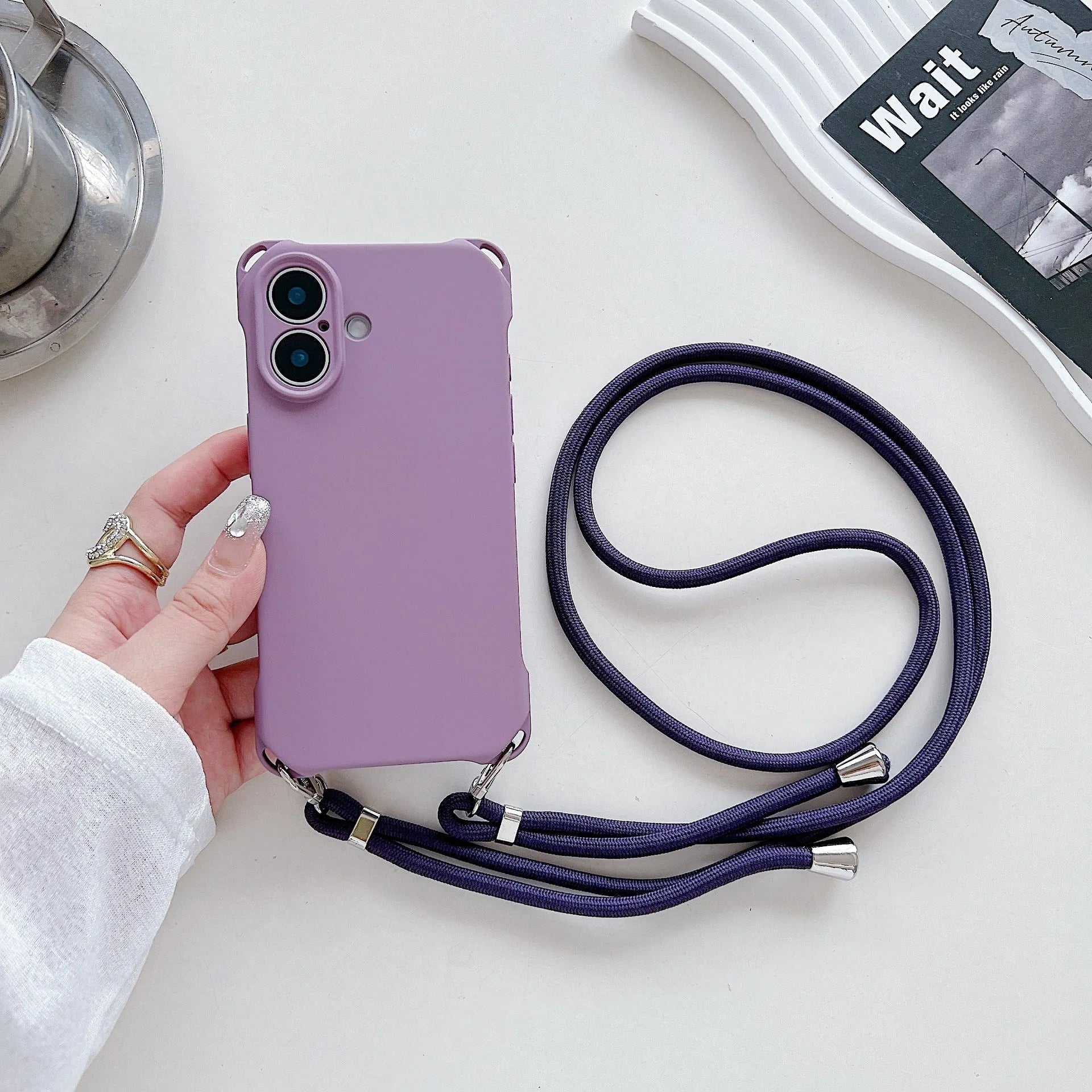 Four-corner cross lanyard liquid silicone phone case for Apple iPhone 16 in antique white with matching lanyard