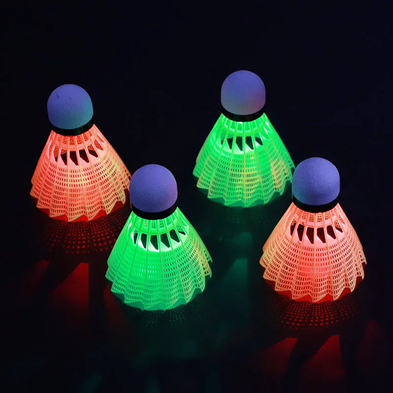 Luminous badminton shuttlecock with green glow, nylon construction, lying on court surface