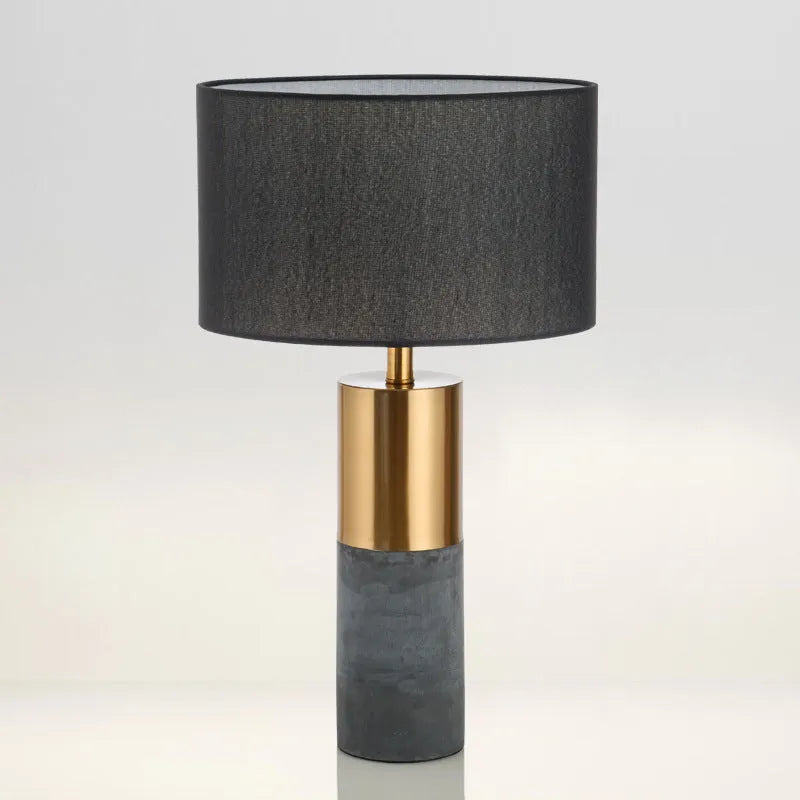Simple designer industrial style table lamp in dark gray on a wooden desk with ambient lighting