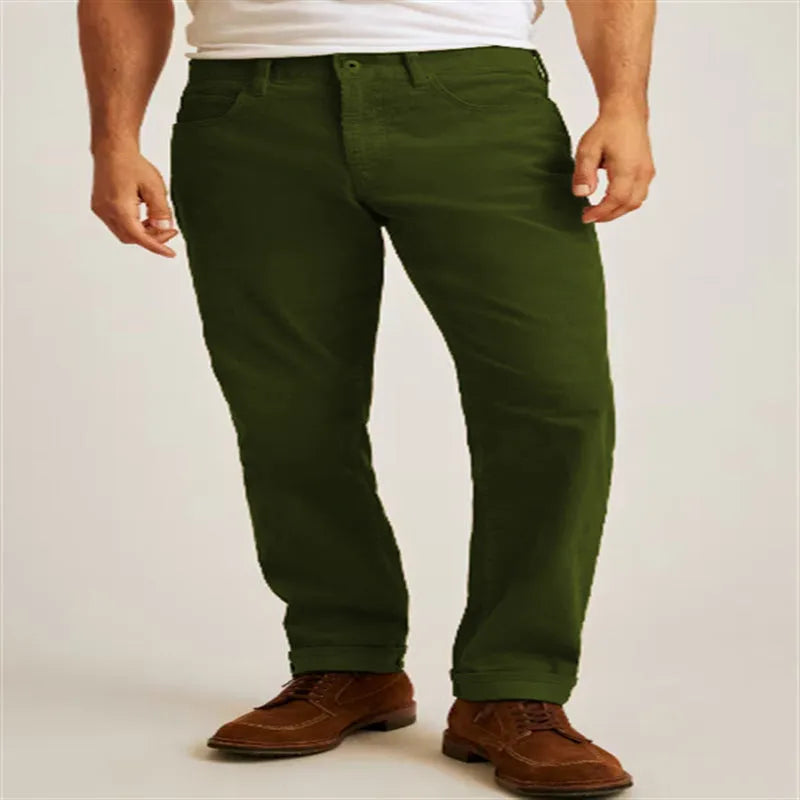 Corduroy straight-leg trousers in green displayed flat showing mid-waist design and zip fly