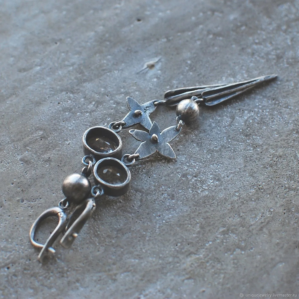 Geometric antique silver long drop earrings with rhinestones and a XINGX design motif.