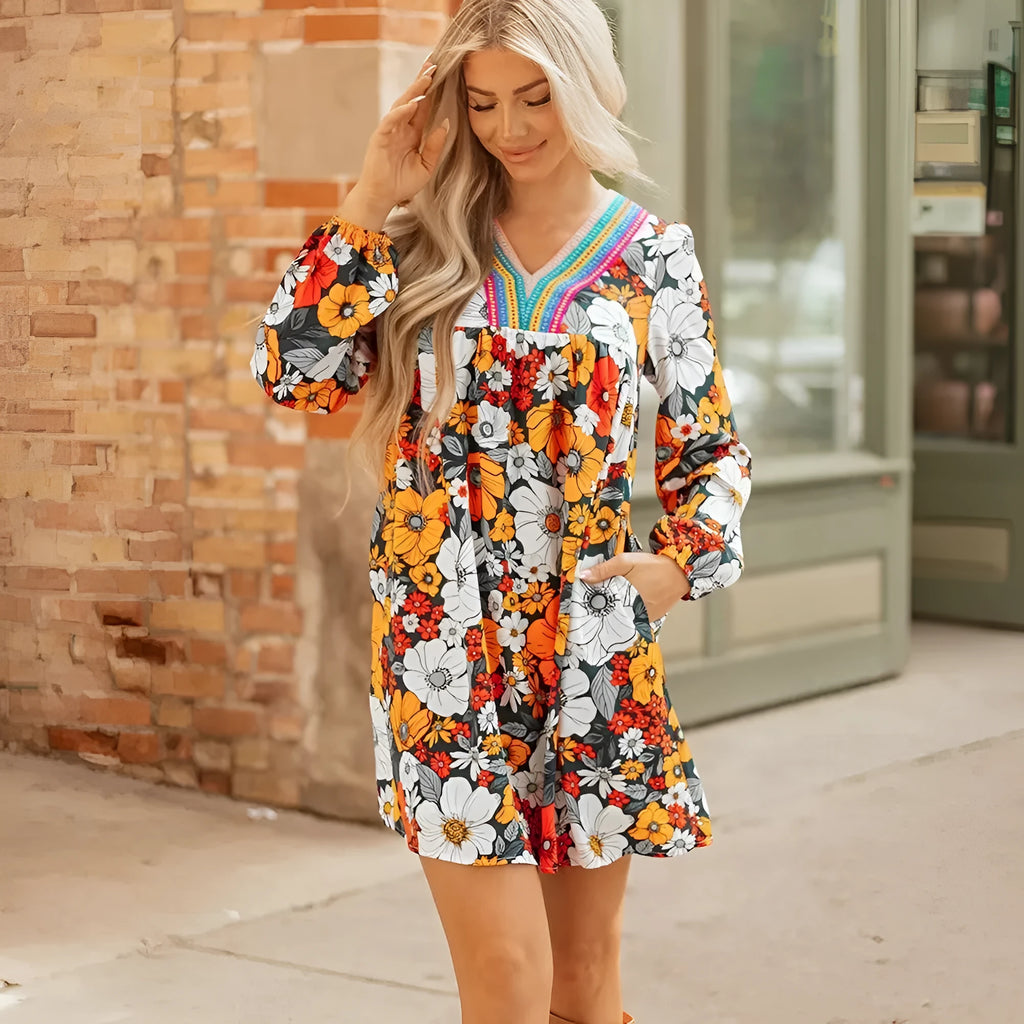 Orange floral print women's mini dress with striped lace detailing, v-neck, and long sleeves