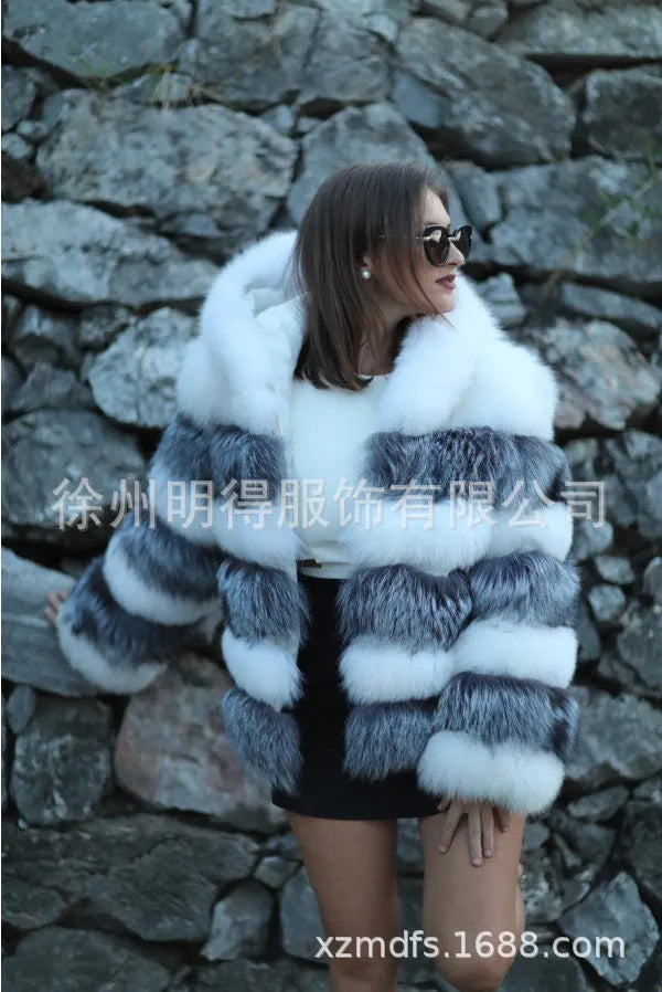 Women's loose fit hooded faux fur coat in brown on a model, showing medium length and street fashion style.