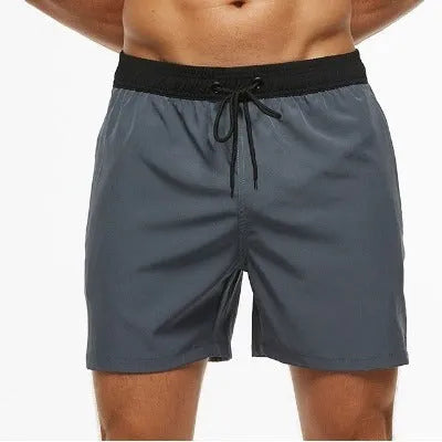 Men's blue athletic shorts with stitching waist detail, drawstring, zipper, and side pockets.