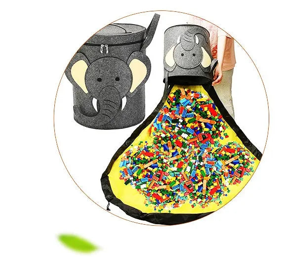 Green felt cube storage bag with pull rope open as a floor play mat for toys.