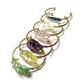 Explosive design natural crystal rough stone bracelet with gold winding on a wrist.