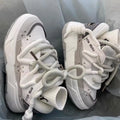 Women's grey retro clunky sneakers with thick rubber platform sole and lace-up front.
