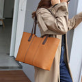 Black genuine leather women's shoulder bag showing multiple internal compartments and single strap