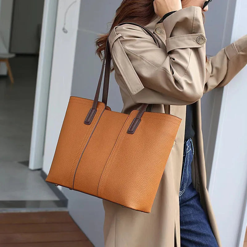 Black genuine leather women's shoulder bag showing multiple internal compartments and single strap