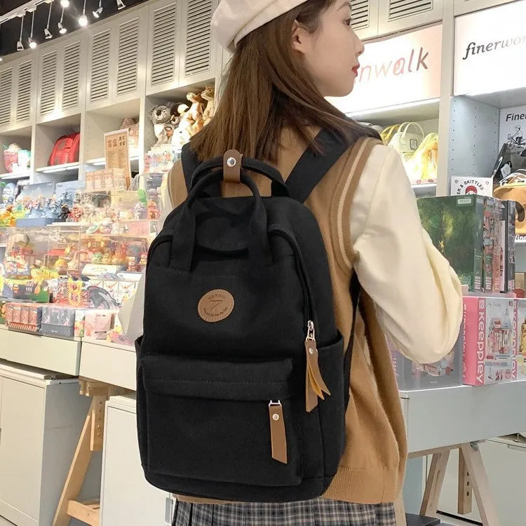 Black oxford cloth fashion backpack with curved shoulder straps and urban simplicity design