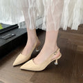 A pair of apricot suede pointed toe stiletto high heels with a rubber sole.