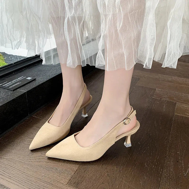 A pair of apricot suede pointed toe stiletto high heels with a rubber sole.