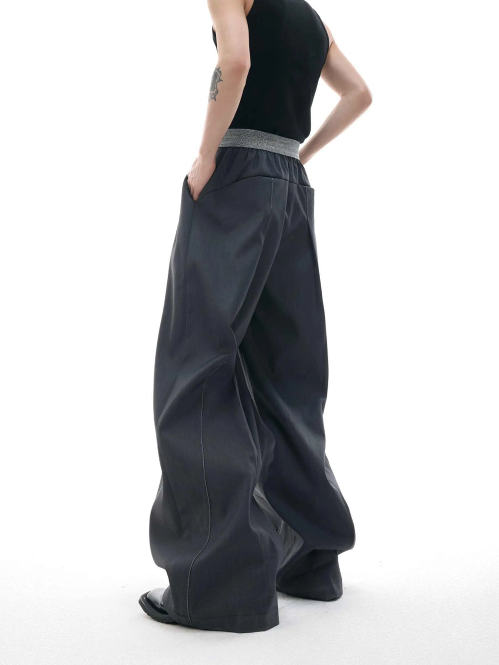 Men's high-waisted straight-leg casual trousers in black with button fly front, showing relaxed fit.
