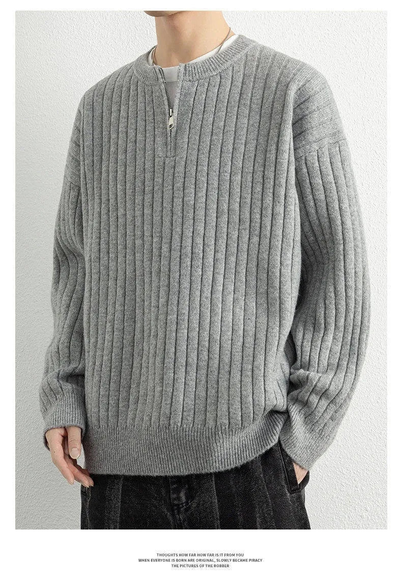 Grey half-zip loose knit sweater for men with long sleeves on a hanger.