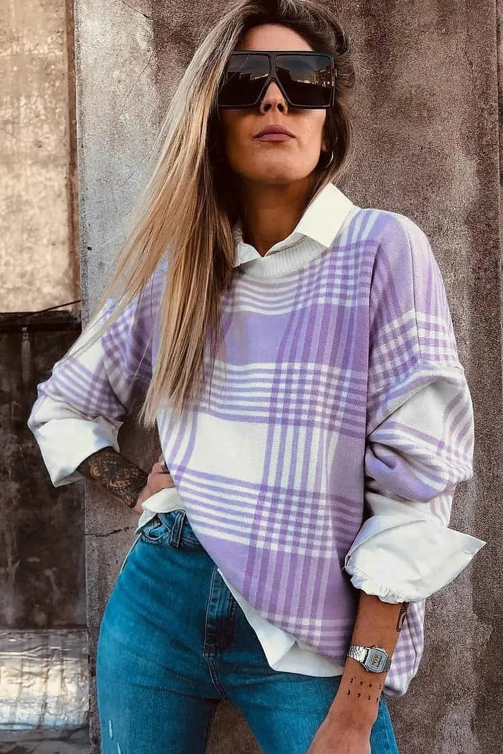 Lilac plaid print loose long sleeve sweater with ribbed cuffs and hem on a hanger.