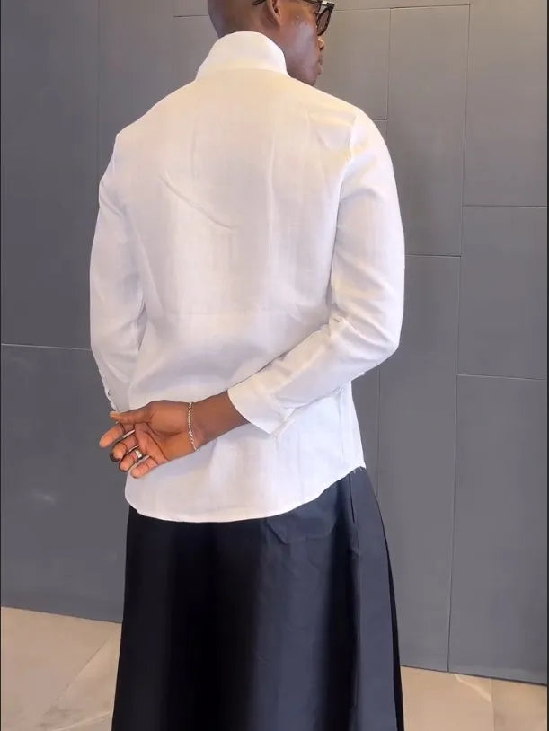 White asymmetrical front long sleeve shirt paired with black pleated trousers in a women's two-piece set.