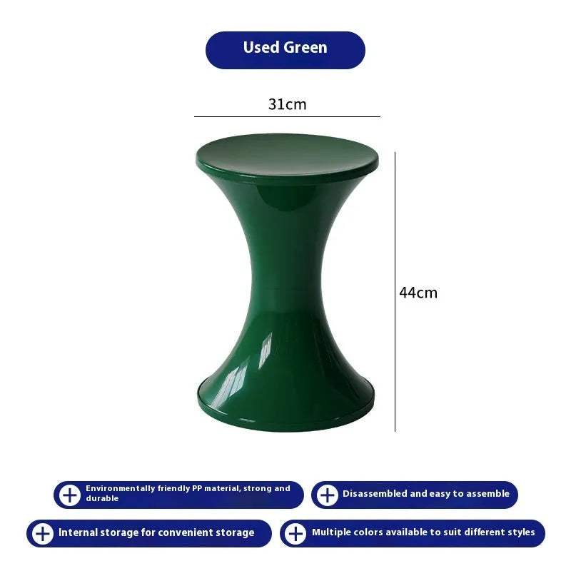 Hourglass-shaped plastic stool in green for changing shoes, used by an adult and child.