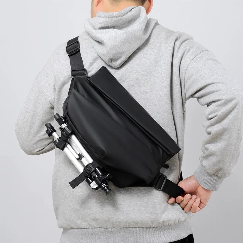 Grey PU leather crossbody sling backpack for men showing horizontal square shape and shoulder strap