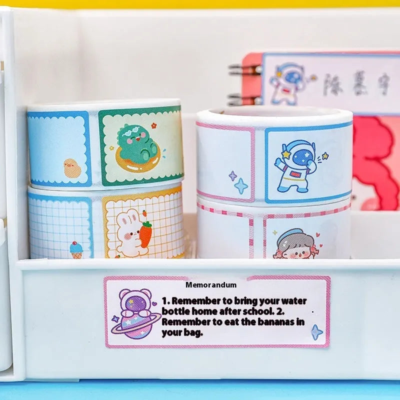 Roll of cartoon name stickers with astronaut, dinosaur, rabbit, and girl designs for student labelling