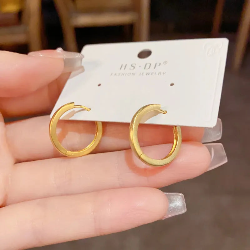 Geometric copper ear clip with round eyelet design in gold plating for women