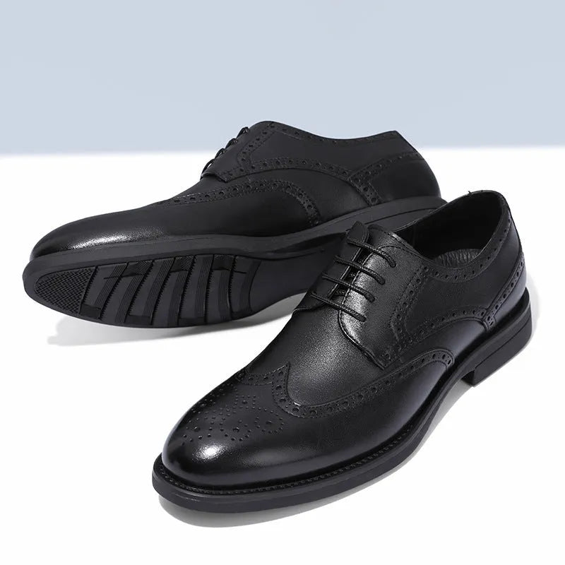 Men's black and brown brogue leather shoes with decorative perforations, shown on a white background.