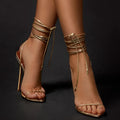 Gold women's ankle strap stiletto sandals with pointed toe and side air detail