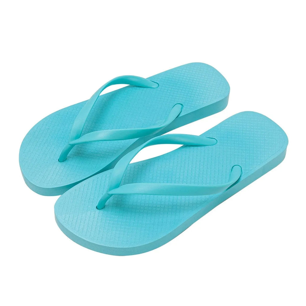Foldable orange casual slippers with non-slip PVC sole and breathable holes, shown on a beach background.