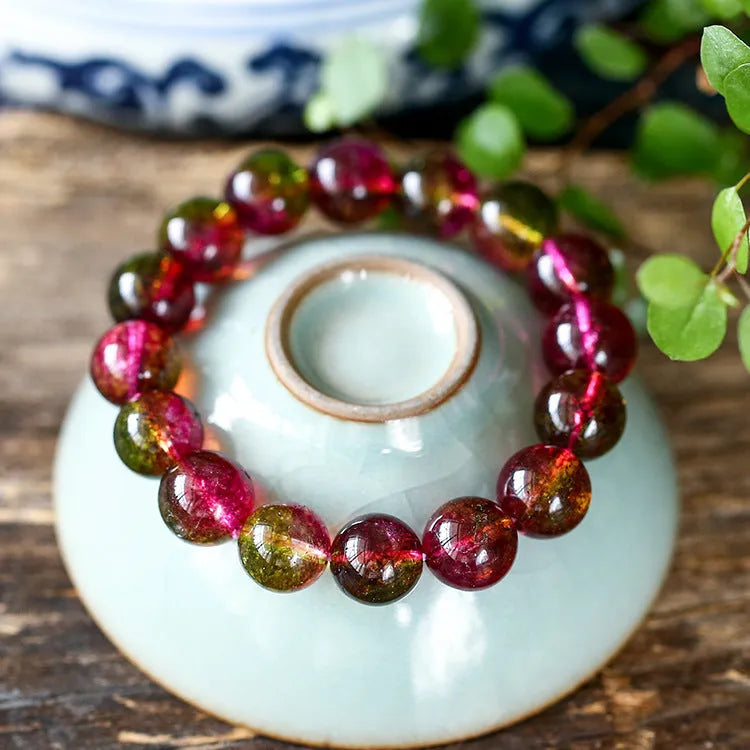 Women's watermelon-coloured crystal bracelet with pastoral design, shown in different size options.