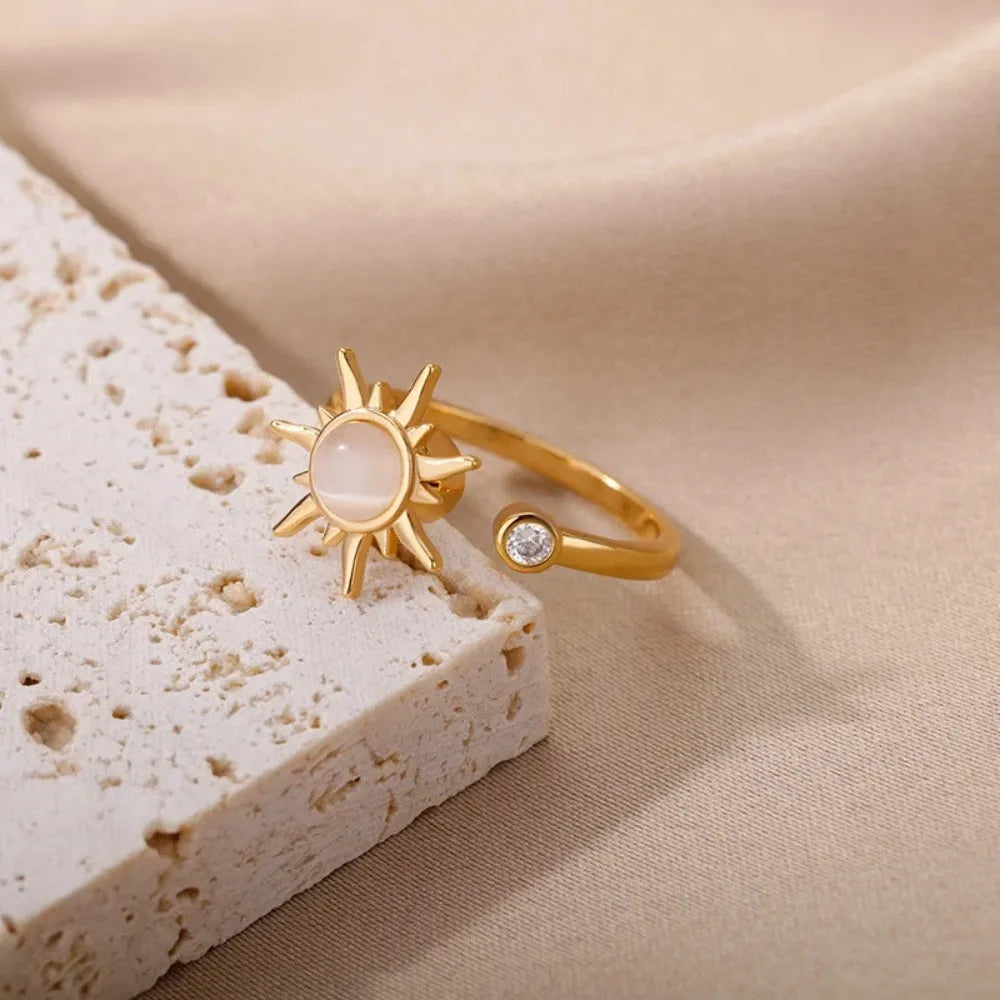 Simple open mouth adjustable copper ring in gold colour on a grey background