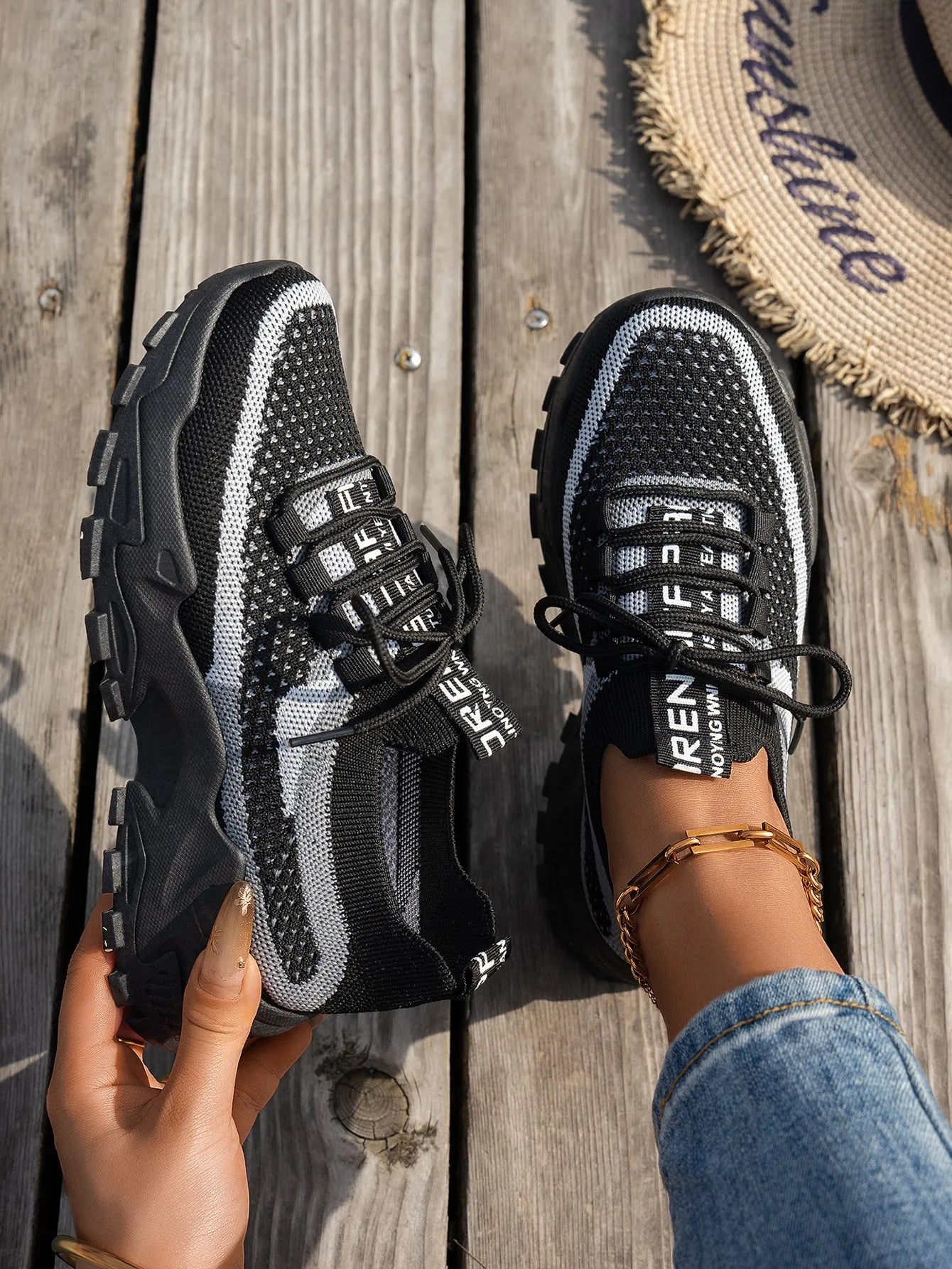 Women's Flyknit mesh lace-up sneakers in a selection of colours, showing round toe and flat rubber sole.