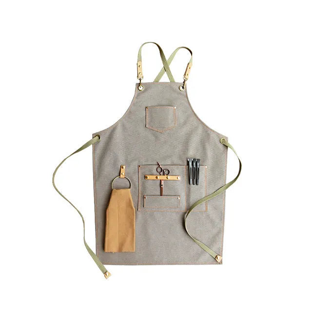 Canvas apron with cross-back straps in camel colour, shown laid flat