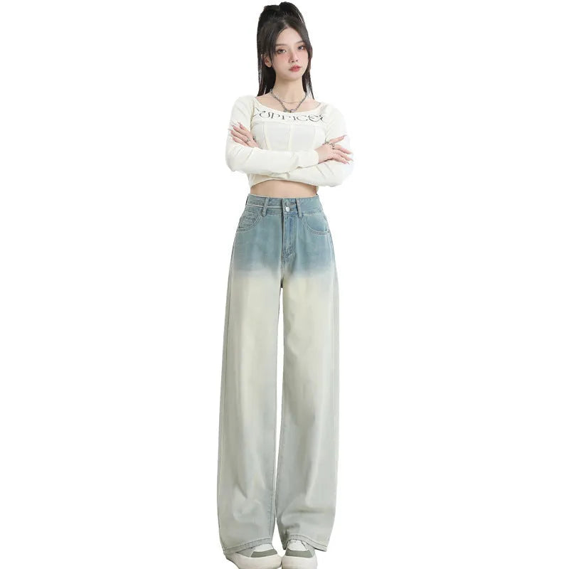 Women's gradient blue denim straight-leg wide-leg trousers laid flat, showing colour fade.