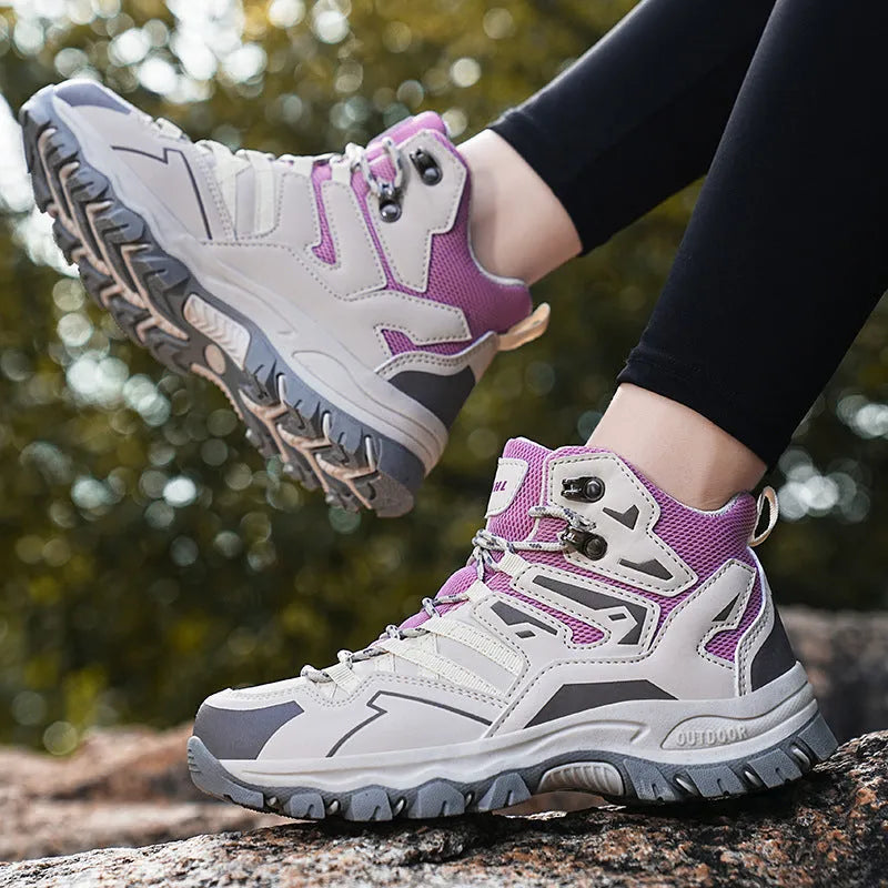 A pair of low-top hiking sneakers with a flannel upper and rubber sole, shown on a rocky mountain path.