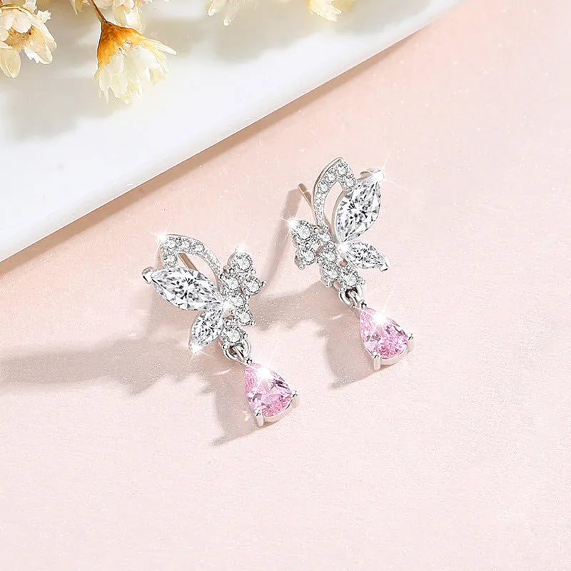 Close-up of women's butterfly stud earrings in sterling silver with clear rhinestone details.