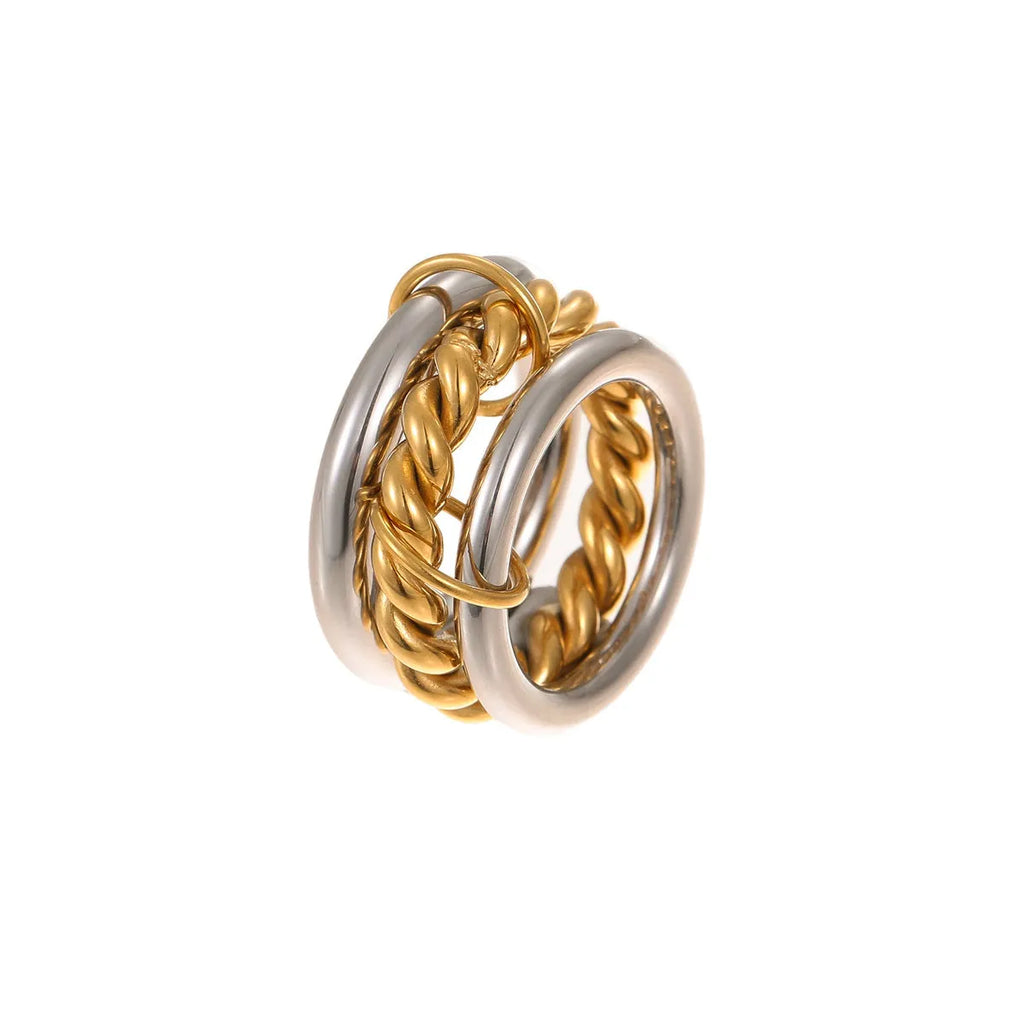 Stacked stainless steel rings with 18K gold plating in exaggerated design on woman's hand