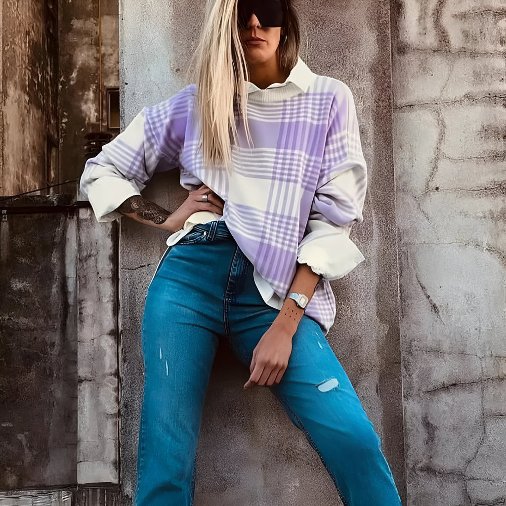 Lilac plaid print loose long sleeve sweater with ribbed cuffs and hem on a hanger.