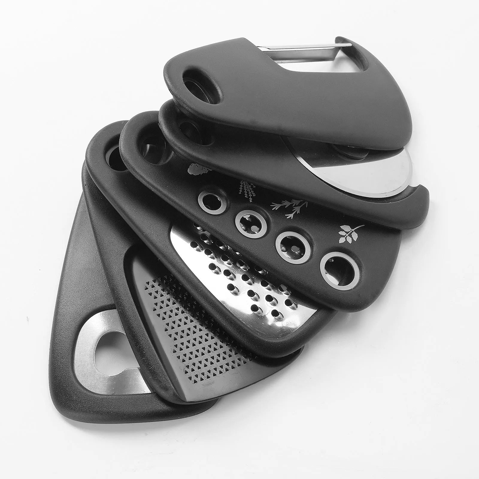 Six stainless steel kitchen gadgets and a brush stored in a modern simple colour box.
