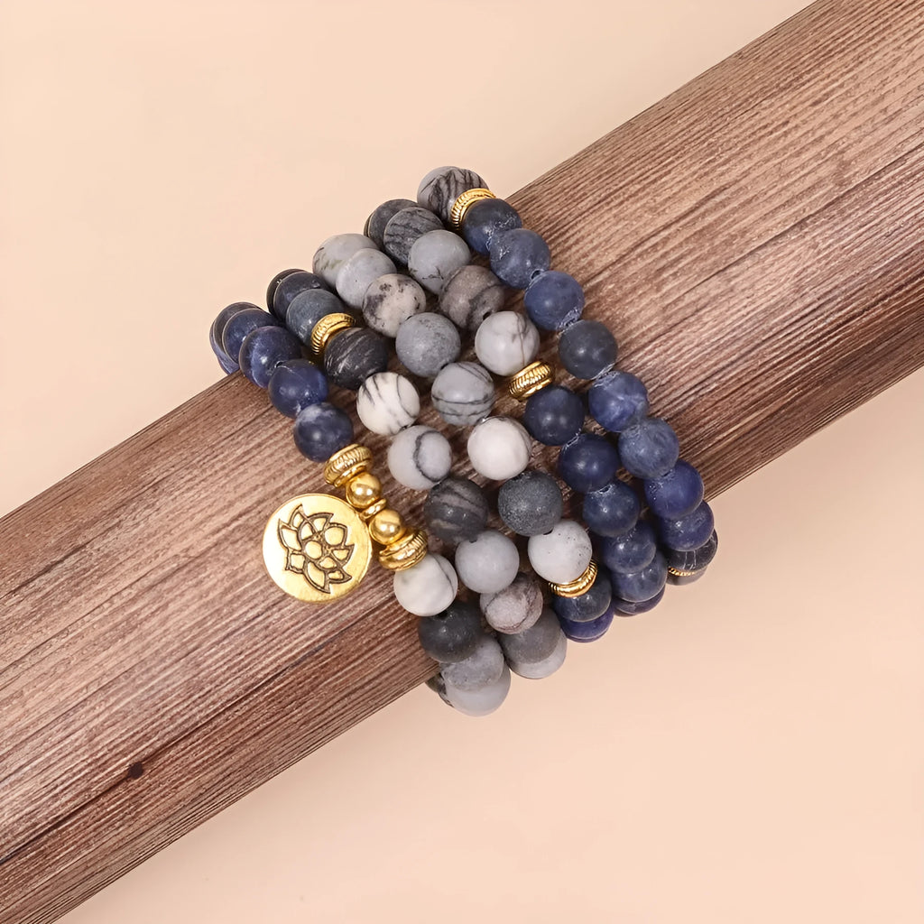 Blue multi-layer bracelet with patterned network stone beads on an alloy chain.