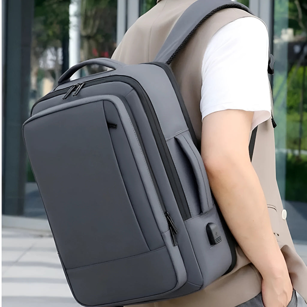 Black waterproof Oxford cloth business backpack with curved shoulder strap showing laptop compartment