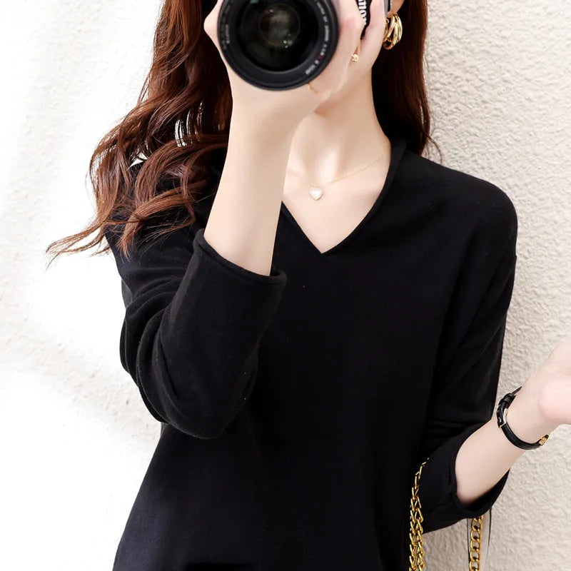 Women's V-neck long sleeve knitwear pullover top in a non-ironing material on a hanger.