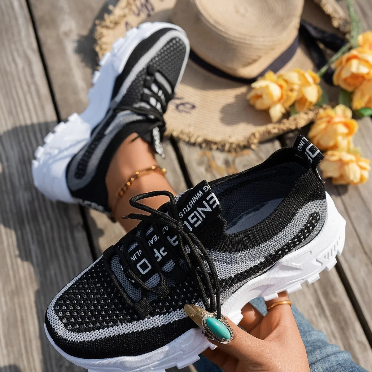 Women's Flyknit mesh lace-up sneakers in a selection of colours, showing round toe and flat rubber sole.