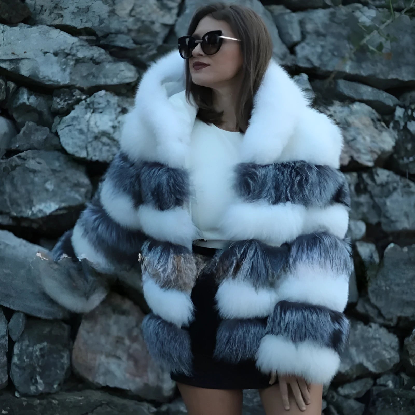 Women's loose fit hooded faux fur coat in brown on a model, showing medium length and street fashion style.