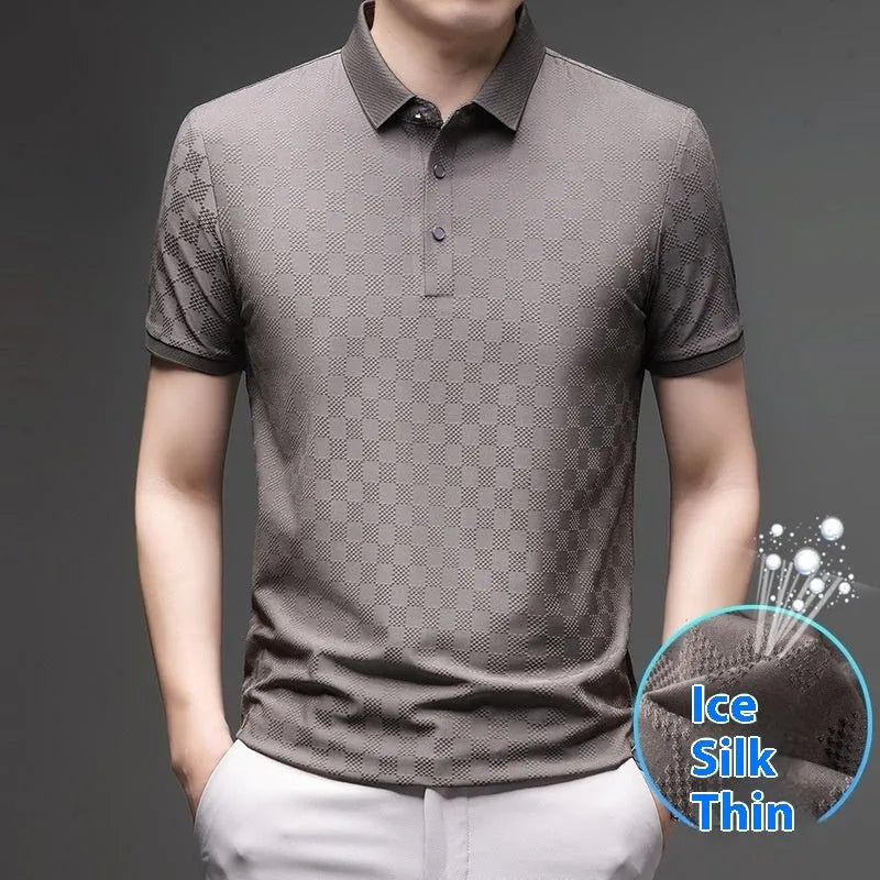 Man wearing a black rhombus patterned short sleeve t-shirt with a side slit detail.