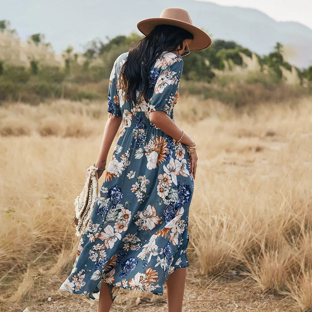 Yellow floral print women's dress with V-neck, short sleeves, elastic high waist, and a full mid-length skirt.
